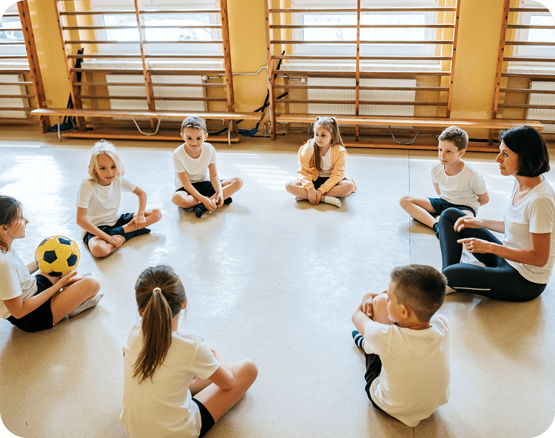 Children sitting in a circle with teacher.