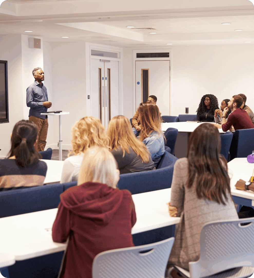 Classroom lecture with attentive students listening.